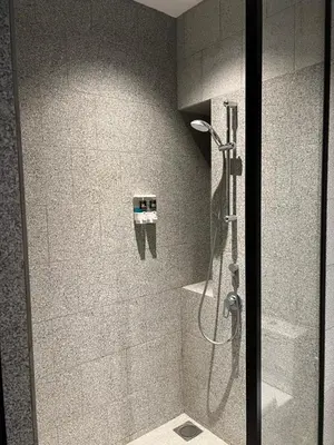 a shower in a bathroom with a glass door at scatletz suites klcc by yatie in Kuala Lumpur