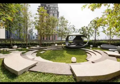 a park with a sculpture in the grass at scatletz suites klcc by yatie in Kuala Lumpur