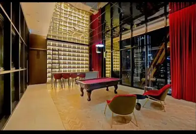 a room with a ping pong table and chairs at scatletz suites klcc by yatie in Kuala Lumpur