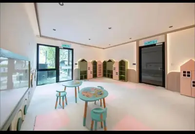 a room with two tables and stools in a store at scatletz suites klcc by yatie in Kuala Lumpur