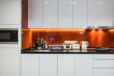 a kitchen with white cabinets and a counter top at Arcoris Mont Kiara 12# Deluxe 2 Bedroom # Coner with Balcony #1-4Pax in Kuala Lumpur