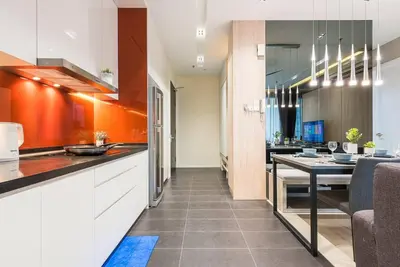 a kitchen with orange walls and a dining room at Arcoris Mont Kiara 12# Deluxe 2 Bedroom # Coner with Balcony #1-4Pax in Kuala Lumpur