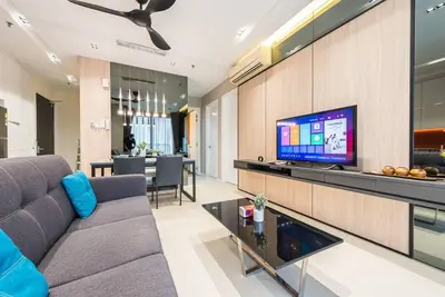 a living room with a couch and a tv at Arcoris Mont Kiara 12# Deluxe 2 Bedroom # Coner with Balcony #1-4Pax in Kuala Lumpur