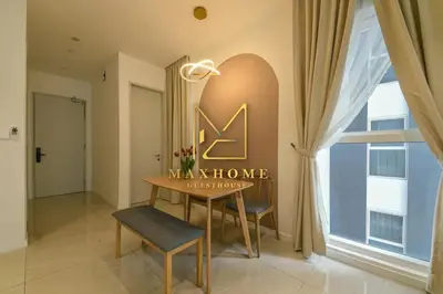 a dining room with a table and a sign on the wall at Maxhome Premium at Quill Residence KL City Centre in Kuala Lumpur