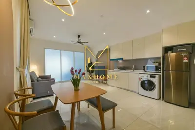 a kitchen with a table and chairs and a refrigerator at Maxhome Premium at Quill Residence KL City Centre in Kuala Lumpur