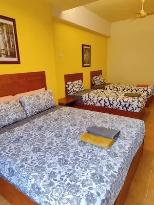 two beds in a room with yellow walls at Fahrenheit88 2minsPavilionKL TRX by Abby Stay in Kuala Lumpur
