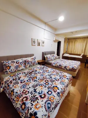 a bedroom with two beds and a couch at Fahrenheit88 2minsPavilionKL TRX by Abby Stay in Kuala Lumpur