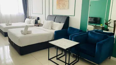 a hotel room with two beds and a couch at Chambers Residences ZFJ World in Kuala Lumpur