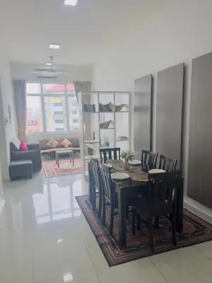 a dining room and living room with a table and chairs at klcc view VUE residences Hkl 2 in Kuala Lumpur
