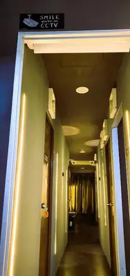 a hallway in a building with green walls and a sign at Guesthouse@ Bukit Bintang in Kuala Lumpur