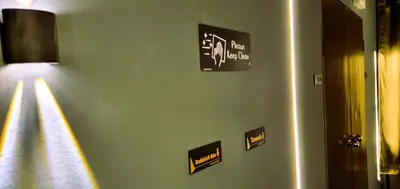 a green wall with stickers on it at Guesthouse@ Bukit Bintang in Kuala Lumpur