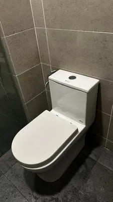 a white toilet sitting in a bathroom stall at Cozy Studio Kuala Lumpur by LH in Kuala Lumpur