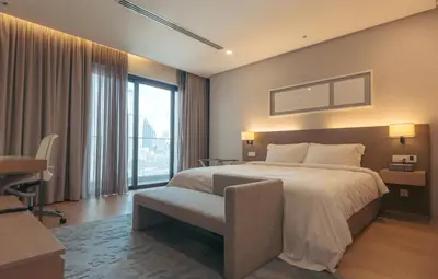 a bedroom with a bed and a desk and a window at Sfera Residence Kuala Lumpur City Centre in Kuala Lumpur