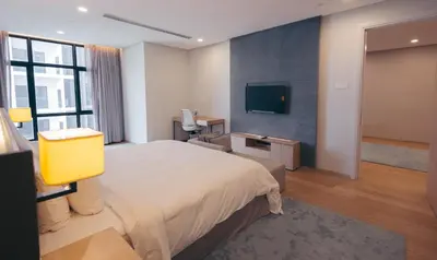 a hotel room with a bed and a television at Sfera Residence Kuala Lumpur City Centre in Kuala Lumpur