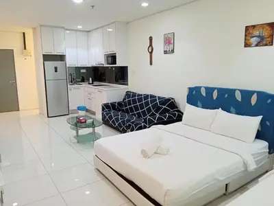 a living room with a bed and a kitchen at Diamond Suite KL at Mercu Summer Suite KLCC in Kuala Lumpur