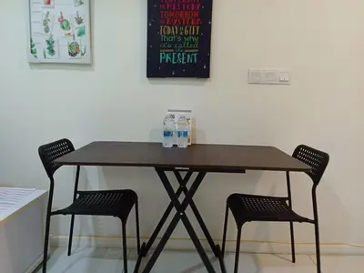 a wooden table with two chairs in a room at Diamond Suite KL at Mercu Summer Suite KLCC in Kuala Lumpur