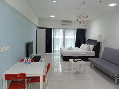 a living room with a bed and a couch at Diamond Suite KL at Mercu Summer Suite KLCC in Kuala Lumpur