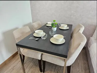 a black dining room table with chairs and a black table with cups and dishes at KL City Suites 2-4pax near KLCC & Bukit Bintang in Kuala Lumpur