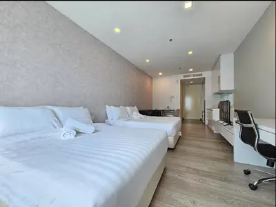 a hotel room with two beds and a desk at KL City Suites 2-4pax near KLCC & Bukit Bintang in Kuala Lumpur