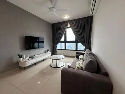a living room with a couch and a tv at M Vertica KL City in Kuala Lumpur