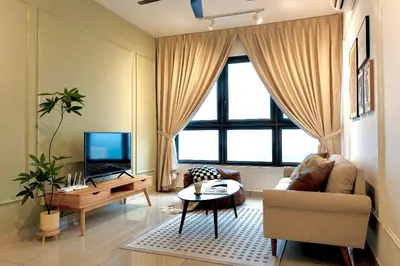 a living room with a couch and a tv at M Vertica KL City in Kuala Lumpur
