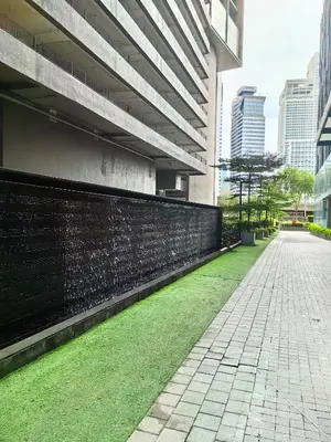 a sidewalk next to a building with green grass at Summer Suites KLCC By Palace in Kuala Lumpur