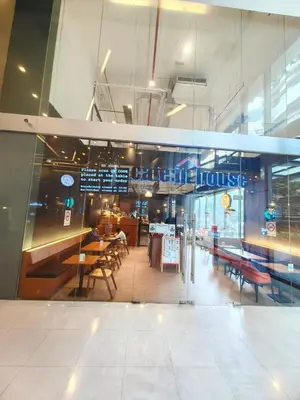 a restaurant with tables and chairs in a building at Summer Suites KLCC By Palace in Kuala Lumpur