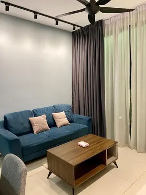 a living room with a blue couch and a coffee table at Infinite Pool! Room in Kuala Lumpur in Kuala Lumpur