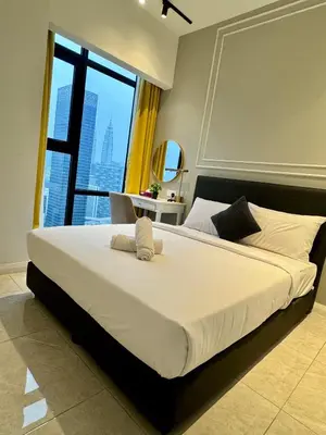 a large bed in a bedroom with a large window at Axon Infinity Pool KL in Kuala Lumpur