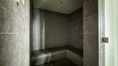 a walk in shower with a tiled wall at Springtime 2bedrooms with KLCC view &Gorgeous pool in Kuala Lumpur