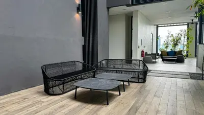 two metal benches and a table in a room at Springtime 2bedrooms with KLCC view &Gorgeous pool in Kuala Lumpur