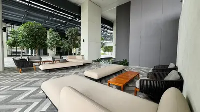 a lobby with couches and chairs in a building at Springtime 2bedrooms with KLCC view &Gorgeous pool in Kuala Lumpur