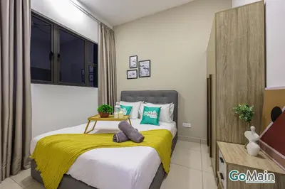 a bedroom with a bed with a yellow blanket at Free Parking - Big Suite Trion Kuala Lumpur by GoMain in Kuala Lumpur