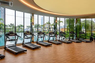 a gym with rows of treadmills in a building at Trion@KL by YourSuperhost in Kuala Lumpur