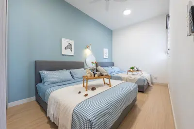 a bedroom with two beds and a couch at Continew Residensi by Feel Home in Kuala Lumpur