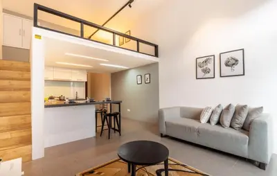 a living room with a couch and a loft at The EST Bangsar Kuala Lumpur in Kuala Lumpur
