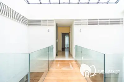 a hallway of a building with glass walls at Damansara Heights by Plush in Kuala Lumpur