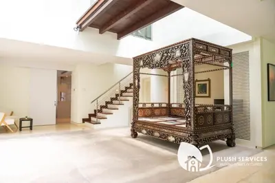 a large mirror in a room with a staircase at Damansara Heights by Plush in Kuala Lumpur