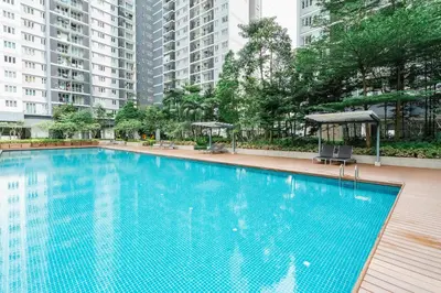 a large swimming pool in a building with tall buildings at Sentul Homestay 3 Bedroom in Kuala Lumpur