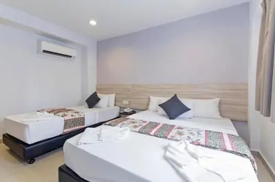 a bedroom with two beds in a room at M HOTEL - Medan Tuanku Near MARA in Kuala Lumpur