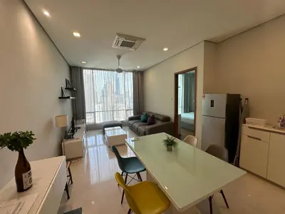 a kitchen and living room with a table and chairs at Soho Suites KLCC 20 jalan perak in Kuala Lumpur