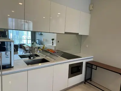 a kitchen with white cabinets and a sink at Soho Suites KLCC 20 jalan perak in Kuala Lumpur