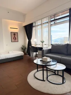 a living room with a couch and a table at Luxhouz Suites at Times Square Kuala Lumpur in Kuala Lumpur