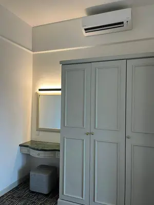 a bathroom with a white closet with a desk at Luxhouz Suites at Times Square Kuala Lumpur in Kuala Lumpur