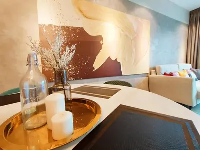 a table with a glass bottle and candles on it at Datum Jelatek Residences Royalty Luxury Apartment, Walking Distance To LRT, Gleneagles KL & KLCC in Kampong Datok Keramat