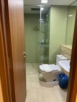 a bathroom with a shower and a toilet and a sink at Vortex Suites KLCC by ZARA in Kuala Lumpur