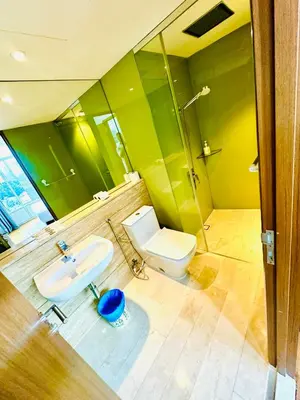 a bathroom with a toilet and a sink and a shower at Vortex Suites KLCC by ZARA in Kuala Lumpur