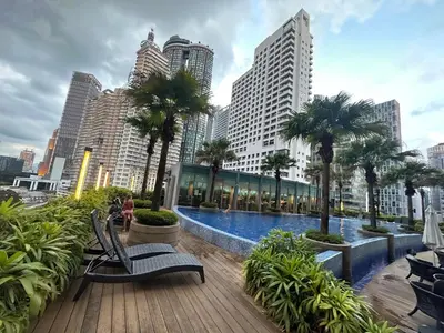 a pool in the middle of a city with tall buildings at Vortex Suites KLCC by ZARA in Kuala Lumpur