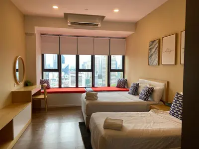a hotel room with two beds and a window at Ceylonz Suites By Staybliss in Kuala Lumpur