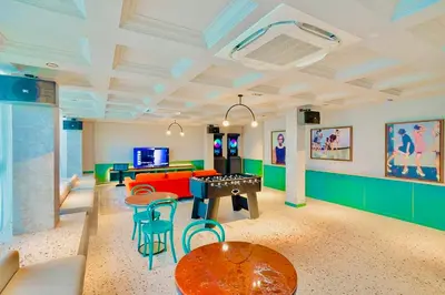 a living room with a ping pong table and chairs at Scarletz suites klcc Bukit Bintang by lulu in Kuala Lumpur